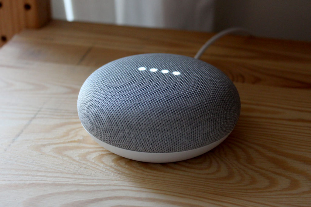 A Google Home Mini smart speaker responding to a request